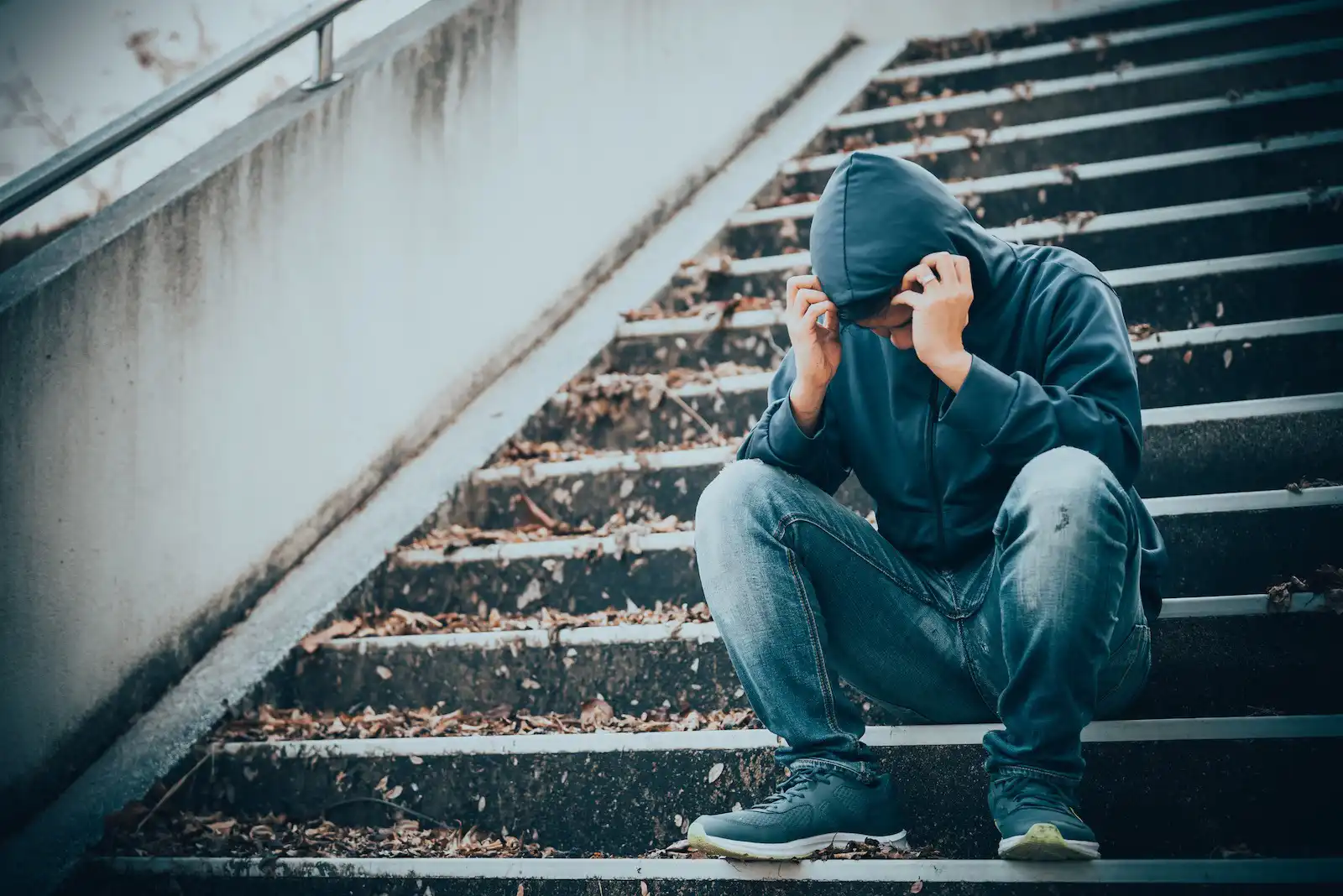 A frustrated man sits on the stairs