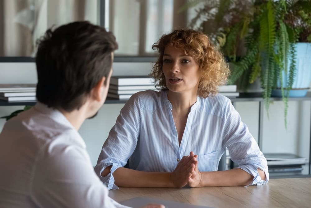 A woman talking to a boss or colleague.