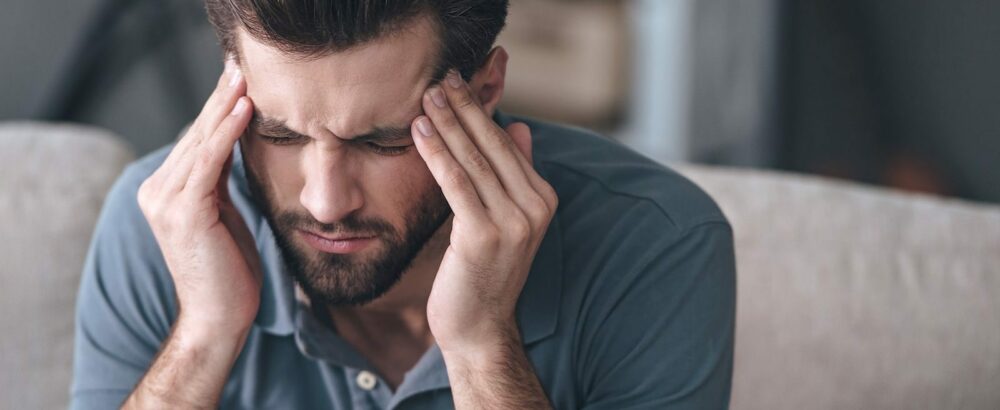 Bearded man with a headache