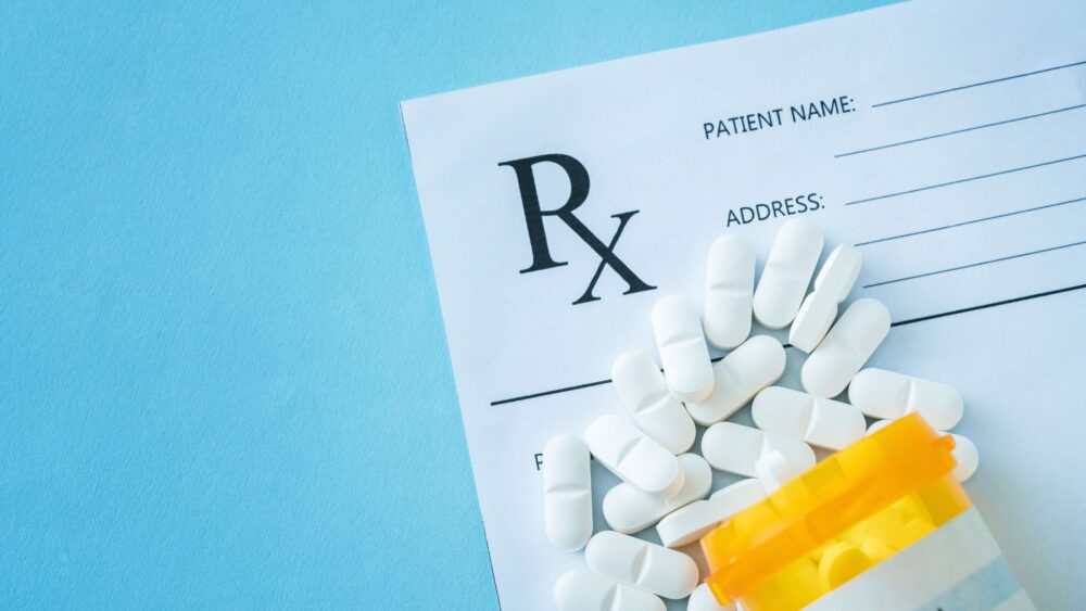 what is tramadol? image depicts a prescription pad with an open pill bottle overtop