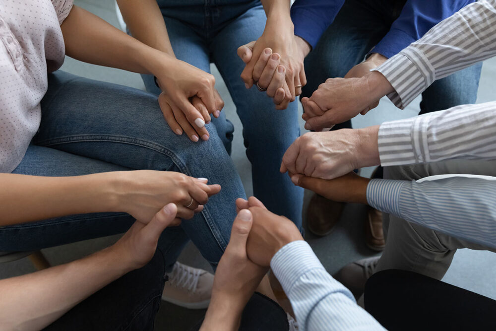 A group of people holding hands.