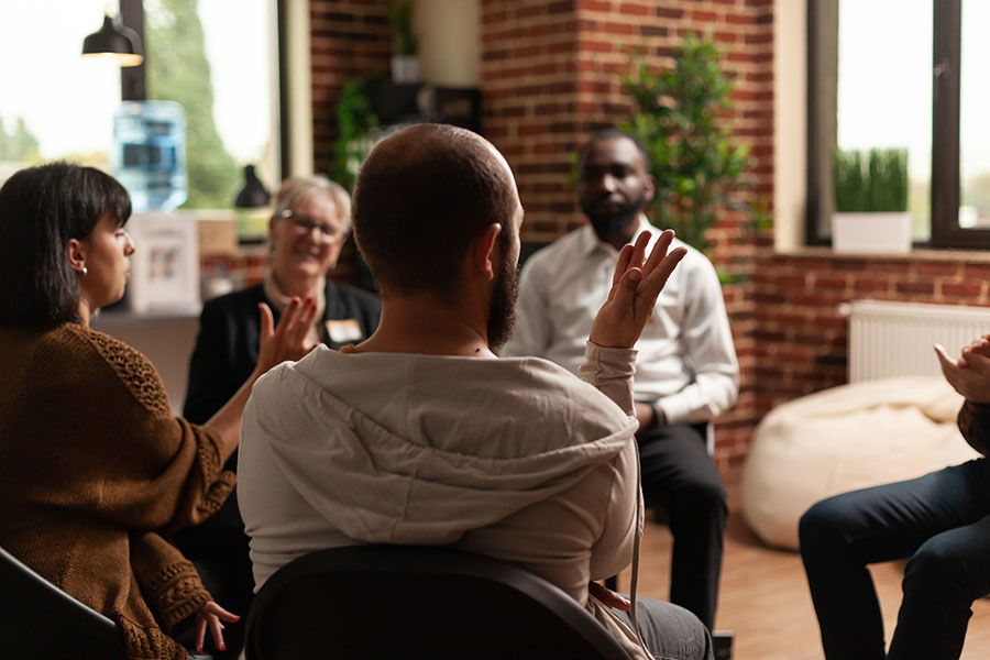 A family takes part in a group therapy session.