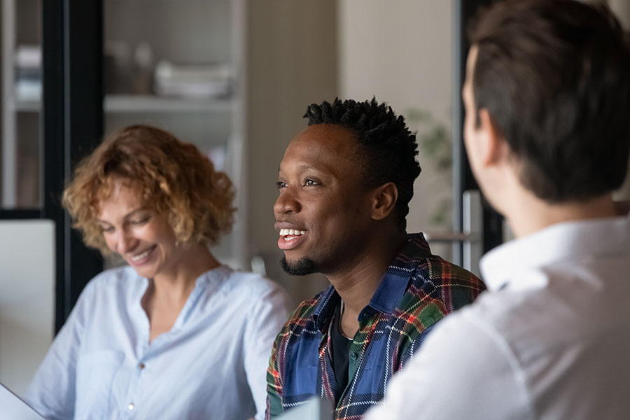 A person recovering from drug addiction has a happy moment in a group session.