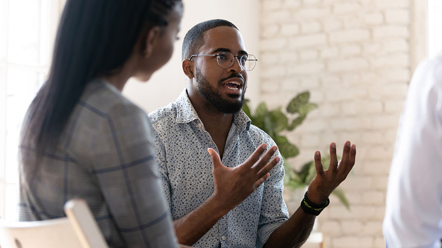 A person in addiction recovery speaks with their friends.