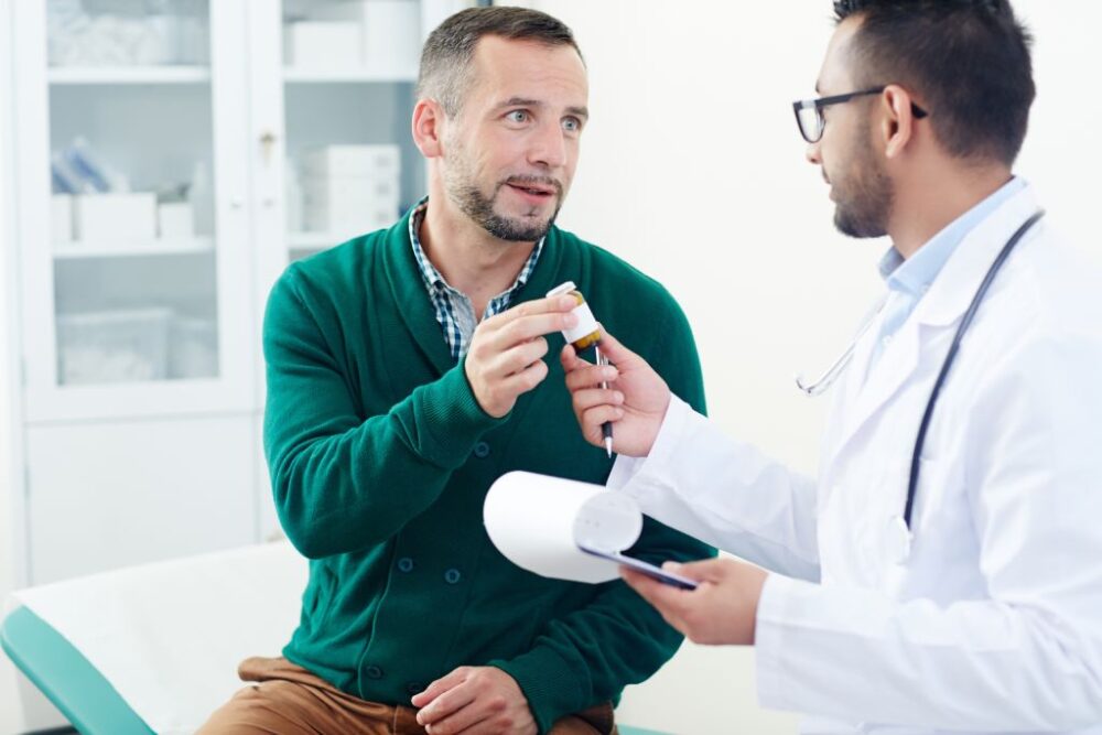 A doctor handing pills to his patient