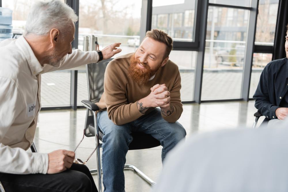 A happy man in group therapy