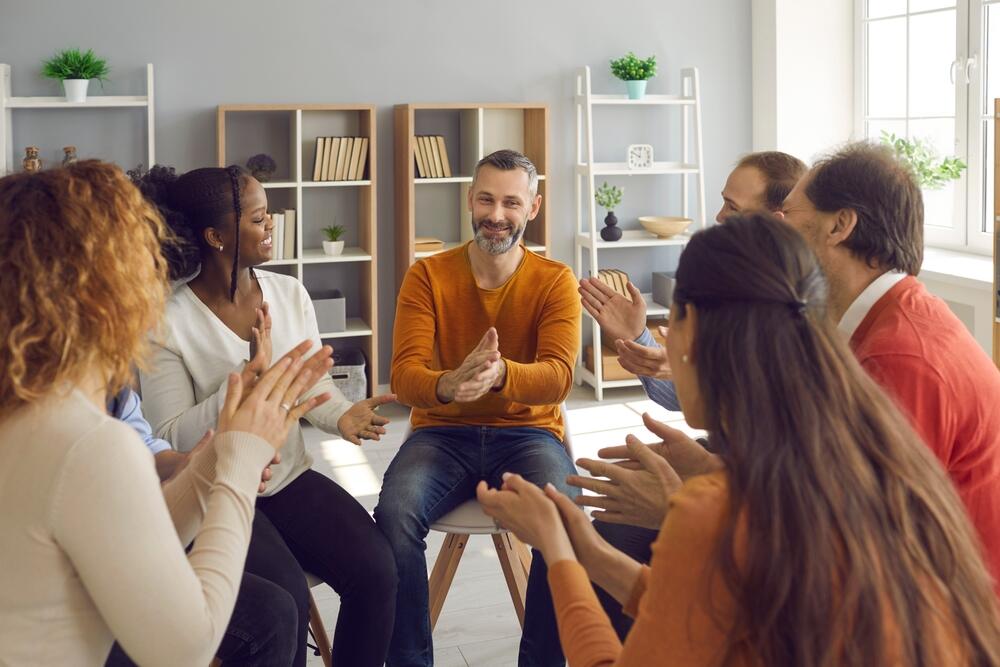 A happy support group clapping