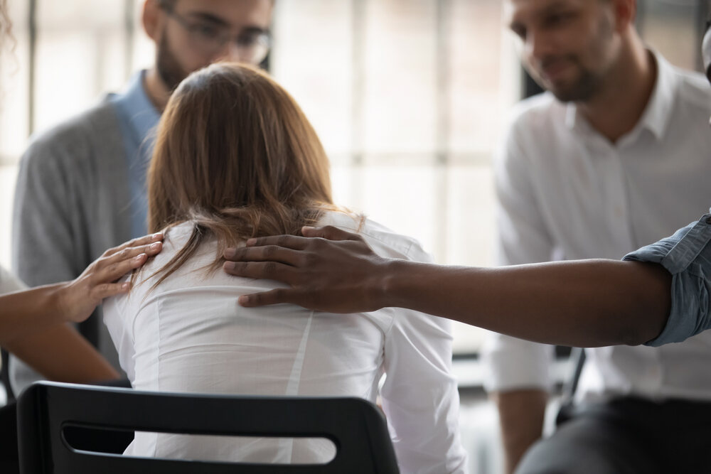 People supporting each other at group therapy 