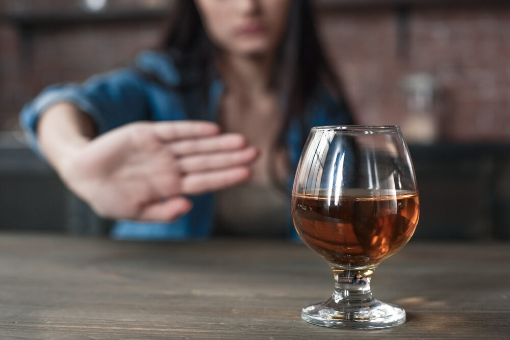 A woman refusing an alcoholic drink